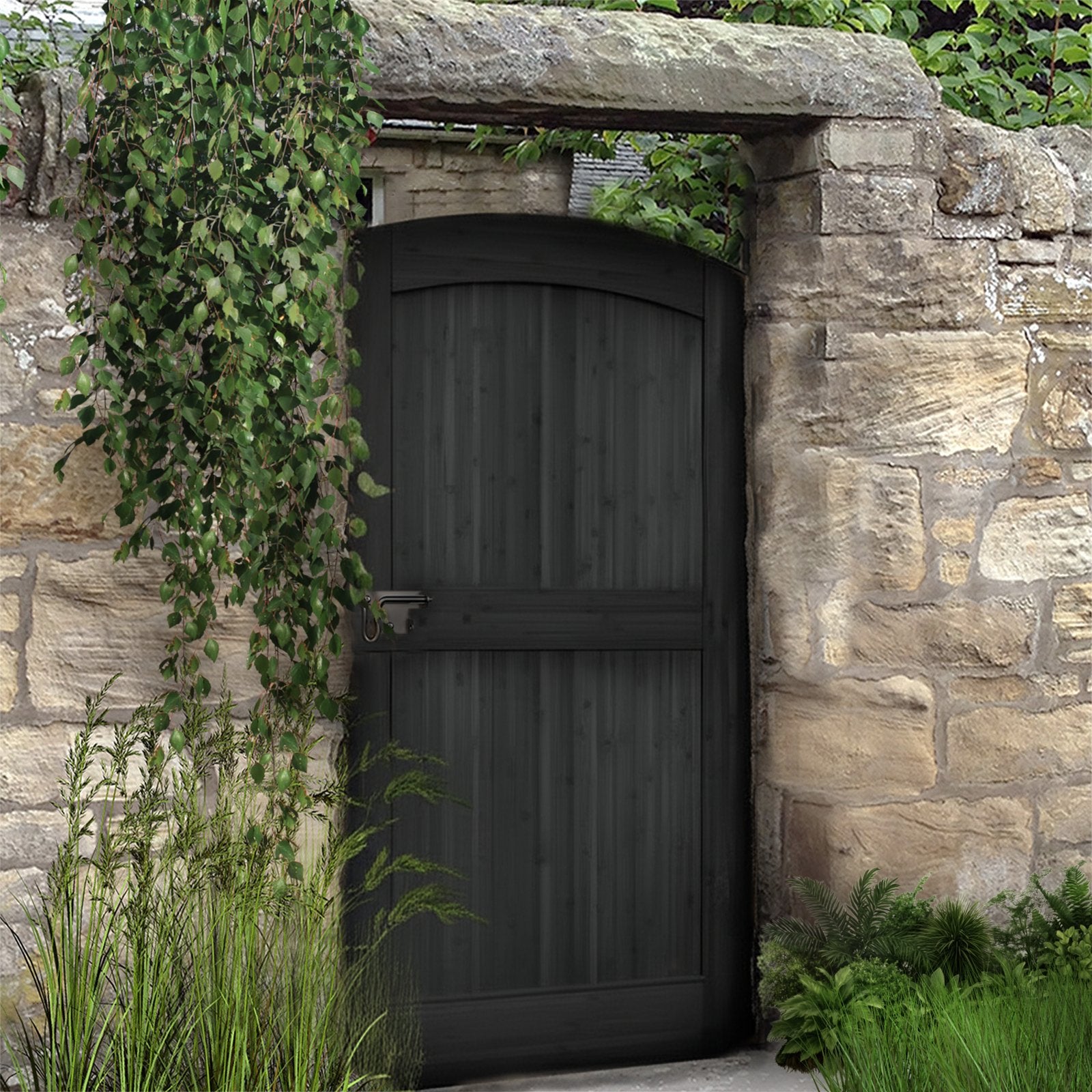 Black-painted arched bamboo gate in a stone wall