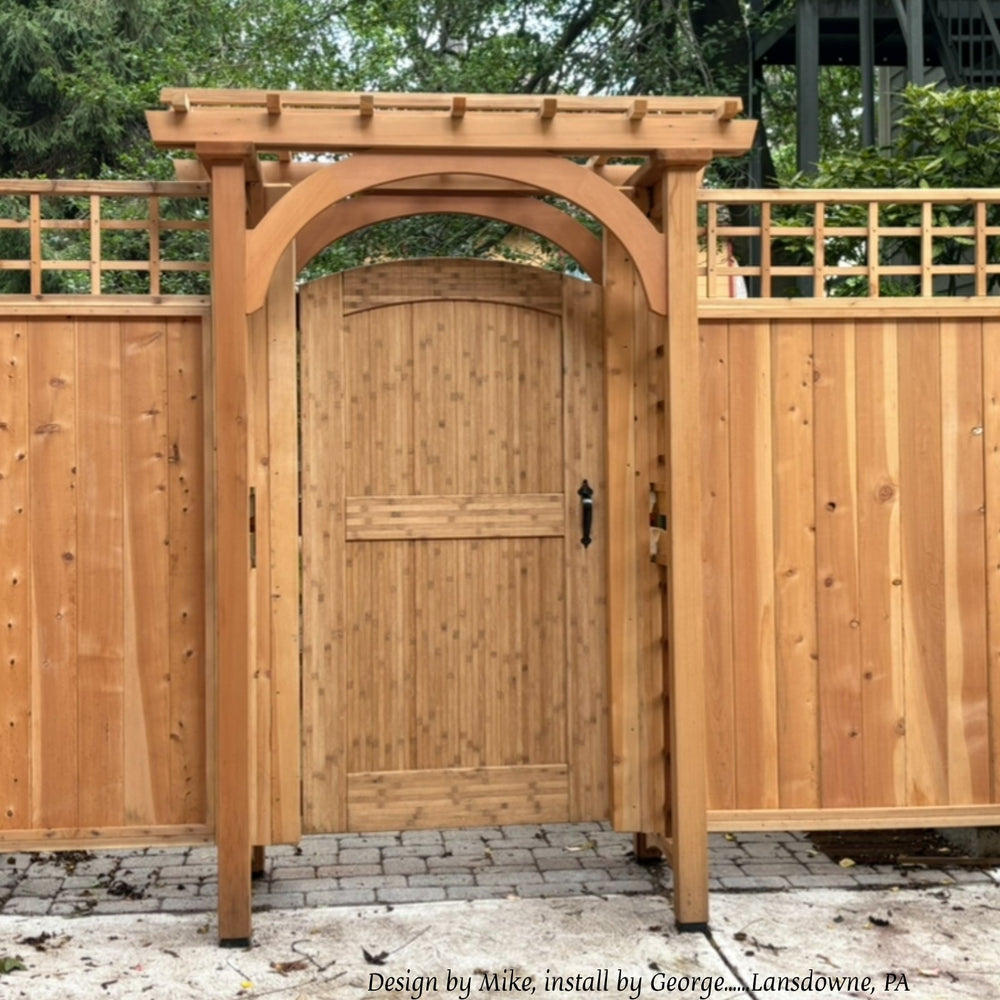 Natural-finish arched bamboo gate under a cedar arbor, Lansdowne, Pennsylvania. Design by Mike, install by George.