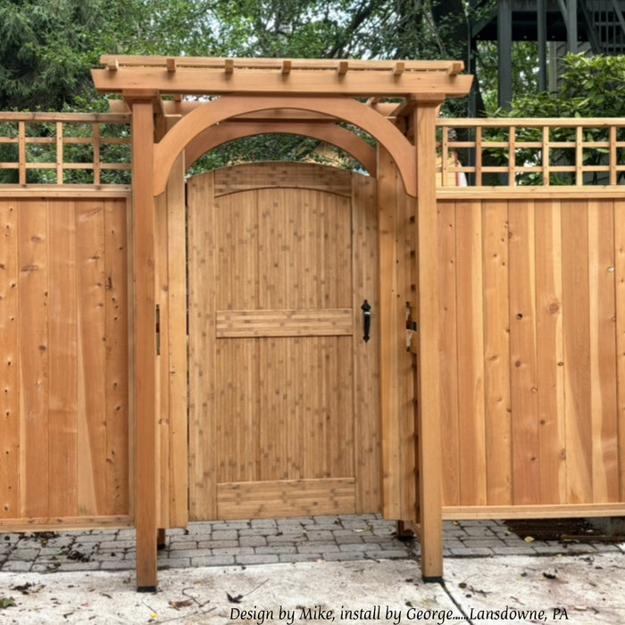 Natural-finish arched bamboo gate under a cedar arbor, Lansdowne, Pennsylvania. Design by Mike, install by George.